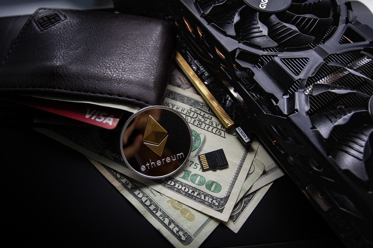 A black leather wallet with a credit card, a silver-colored coin that features the Ethereum logo, and several US dollar bills rest on a dark surface.